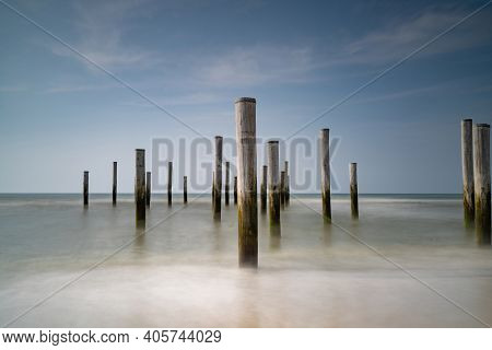 Focus On Flong Exposure Seascape. Taken At The North Sea In Petten With The Pole Village In The Sea,