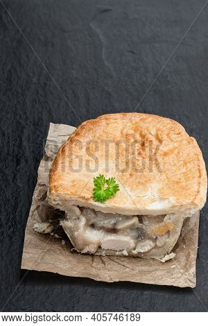 Halved  Pukka Pie Pasty On Black Stone Background