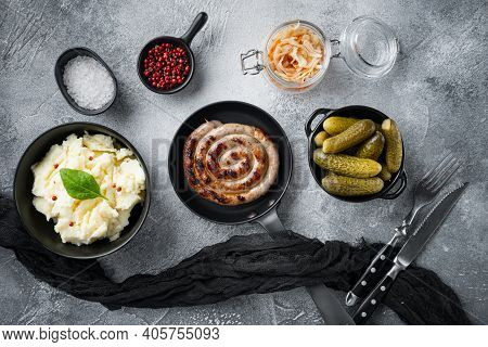 Fried Bavarian German Nürnberger Sausages With Sauerkraut, Mashed Potatoe In Cast Iron Frying Pan, O