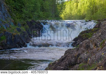 On The Kivach Waterfall On A Sunny June Evening. Karelia, Russia