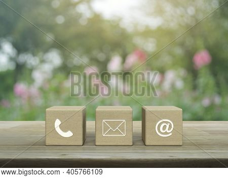 Telephone, Mail, Email Address On Wood Block Cubes On Wooden Table Over Blur Pink Flower And Tree In