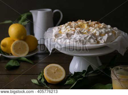 Pavlova Meringue With Lemon Curd On A Rustic Table. High Quality Photo