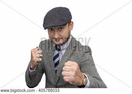 Portrait Of A Man In A Boxing Stance With Brass Knuckles In His Hand On A White Background.the Conce