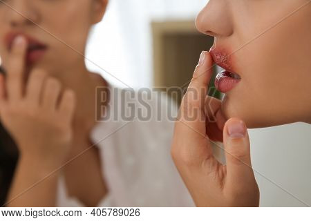 Woman With Herpes Touching Lips In Front Of Mirror, Closeup