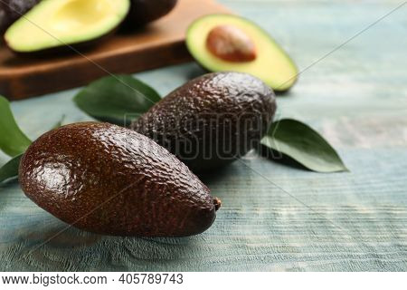 Ripe Hass Avocadoes On Light Blue Wooden Table, Closeup