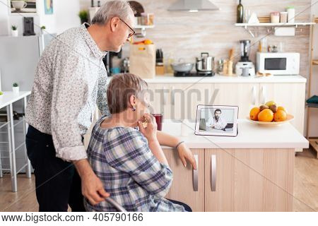 Senior People Using Medical App On Tablet To Talk With Doctor About Her Pills Prescription Online He