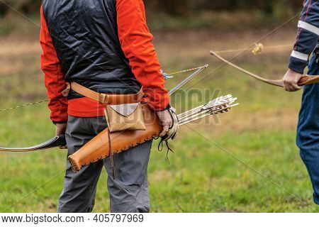 Closeup Of An Archer With Leather Quiver With Arrows And Bow (longbow) Made Of Wood, Archery Sport C