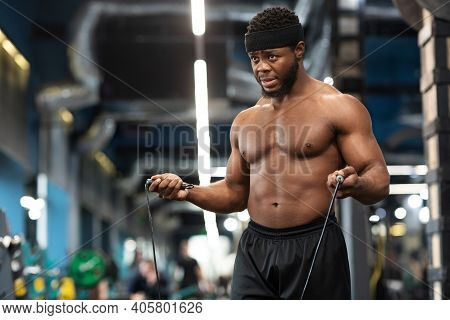 Hot African American Young Man Bodybuilder Warming Up Before Working Out In Gym, Closeup. Shirtless 