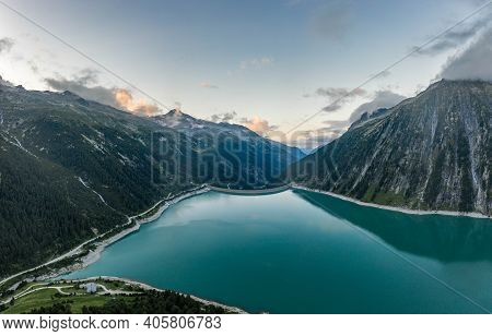 Aerial Drone Shot Of Schlegeisspeicher Resevoir With Galcier View At Dusk