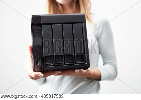 Girl Person Hold In Hands Portable Office Or Home Data Nas Server. Device For Backup Important Infor
