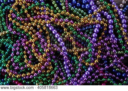 Colorful Mardi Gras Beads Background. Green, Purple And Gold Merdi Gras Beads
