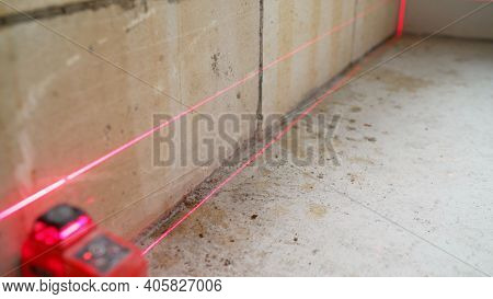 Close-up Of Modern Engineering Device Set On The Floor, Installation Of Laser Level For Measurement 