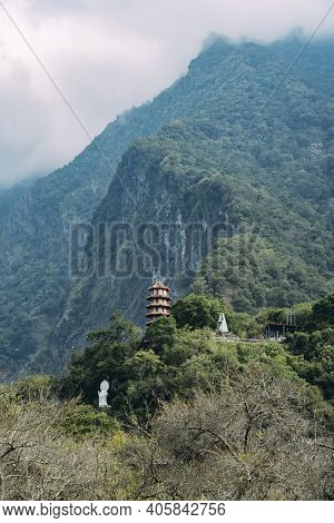Wide View Of Xiangde Temple From Valley Below With Sharp Cliffs Behind.