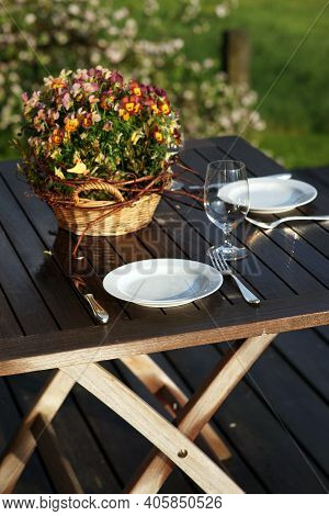 Table Setting For Romantic Dinner For Two On Wooden Table Outside