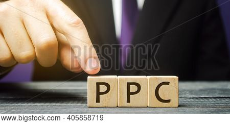 Wooden Blocks With The Word Ppc. Internet Advertising Model Used To Drive Traffic To Websites. Inter