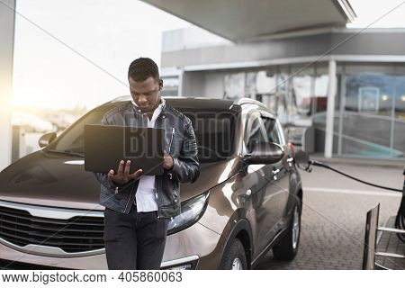 Young Confient African American Businessman, Standing In Front Of His Car And Working On Laptop Pc, 