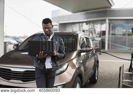 Young Confient African American Businessman, Standing In Front Of His Car And Working On Laptop Pc, 