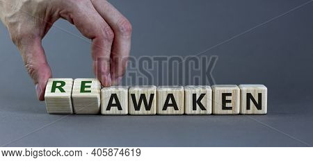 Reawaken Symbol. Businessman Turns Cubes And Changes The Word 'awaken' To 'reawaken'. Beautiful Grey