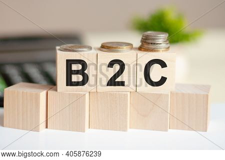 Dollars Banknote With Calculator And Word B2c. Banknotes And Wooden Cubes With Letters. Concept With