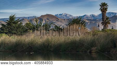 Compressed Landscape View Of Coastal Esturary Pond In Foreground Looking Across Ventura To Snow Cove