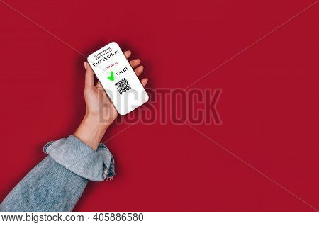 Woman's Hand Holding Smartphone Displaying Valid Digital Vaccination Certificate - Digital Vaccinati