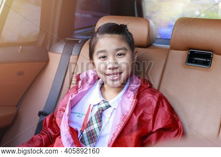Asian Happy Student Smiling With Camera While Enjoying Road Trip In Car. Daughter Smiling And Lookin