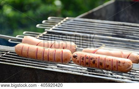Sausages Are Cooked On A Grill On Coals . Bbq, Outdoor Barbecue .