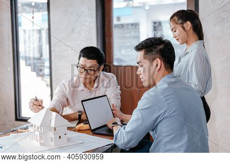 Businessman And Architech Meeting For Planing And Checking House Design And House Model And Secretar