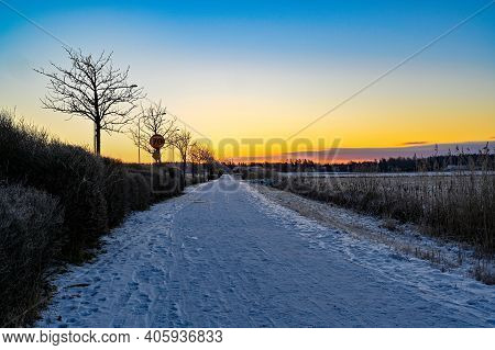 Sunrise Over Cycle Path Covered In Snow