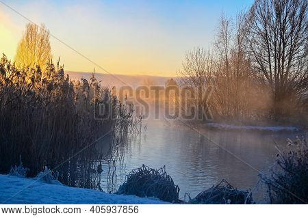 Sunrise And Mist Over Small Pond I Kumla Lakepark Sweden