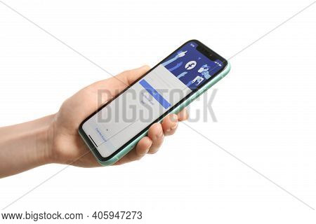 Mykolaiv, Ukraine - July 9, 2020: Woman Holding  Iphone X With Facebook App On White Background, Clo