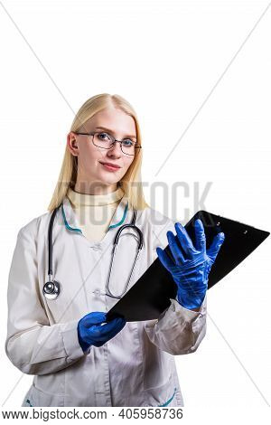 Young Smiling Female Doctor Writing Down Diagnoses