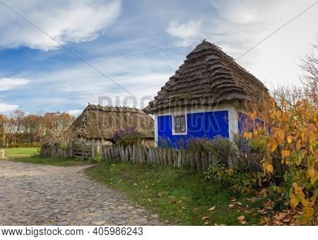 Old Ukrainian Rural House With Blue Decoranive Pattern Of Walls And Thatched Roof Built In The 19th 