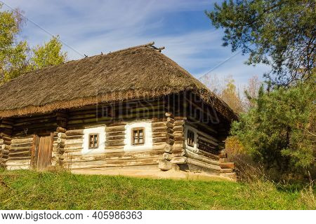 Part Of Old Ukrainian Wooden Rural Log House With Thatched Roof Built In The 19th Century, Autumn Da