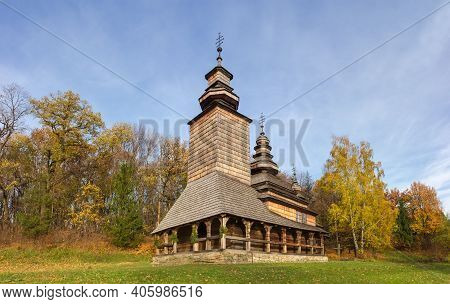 Old Wooden Church Of Veil Of The Mother Of God With Three Domes And Walls And Roof Covered With Wood
