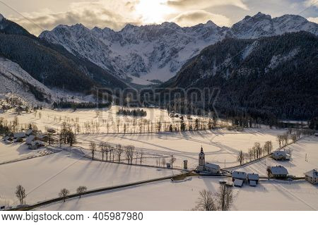 Aerial Winter Landscape With Mountain Village And Forest Covered In Snow. Zgornje Jezersko, Slovenia