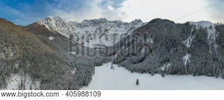 Aerial Winter Landscape Mountain Valley With Forest Covered In Snow. Zgornje Jezersko, Slovenia.