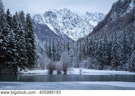 Frozen Winter Lake In The Mountains Covered With Snow. Plansar Lake, Jezersko Slovenia.