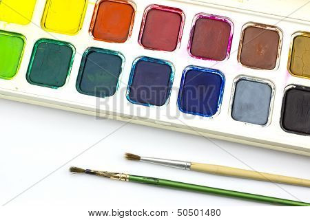 Paint tray and paintbrush on white background