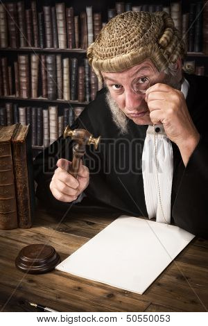 Funny judge looking through an antique monocle