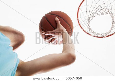 Man attempting to through basketball in to the basket