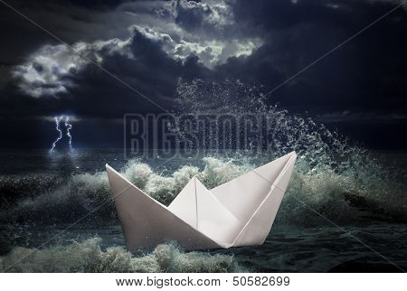 paper ship in storm concept