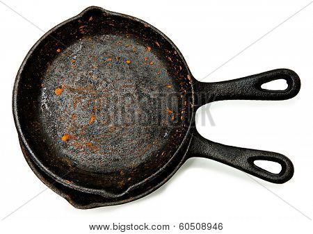 Set of Two Rusty Cast Iron Skillets over white.