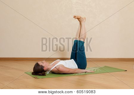 Caucasian Woman Is Practicing Yoga At Studio (salamba Prasarita Padasana)