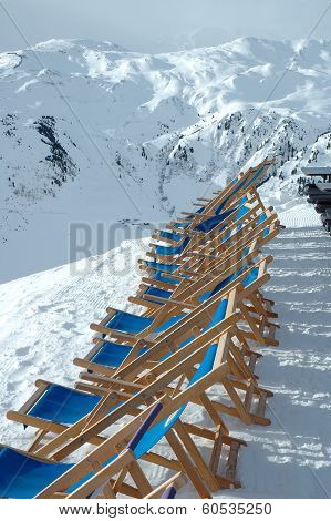 Deckchairs on peak In Alps In Winter