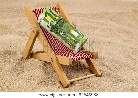 a deck chair with a euro banknote. symbolic photo for saving on holiday and when traveling
