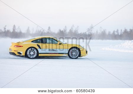 LEVI, FINLAND - FEB 20: Unknown driver powerslides a PORSCHE 911 TURBO car during Porsche Driving Experience Snow & Ice Press Event on February 20, 2014 in LEVI, FINLAND