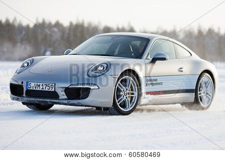 LEVI, FINLAND - FEB 20: Unknown driver powerslides a PORSCHE 911 CARRERA 4S car during Porsche Driving Experience Snow & Ice Press Event on February 20, 2014 in LEVI, FINLAND