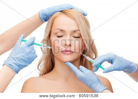 beauty and cosmetic surgery concept - woman with closed eyes and beautician hands with syringes
