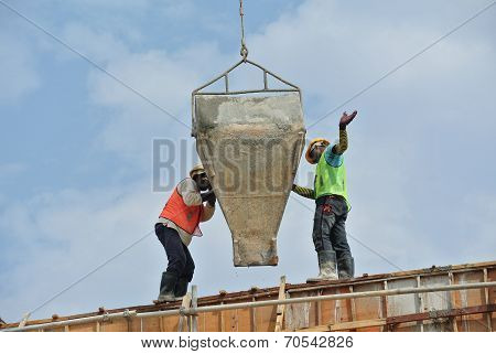 Group of construction workers casting beam